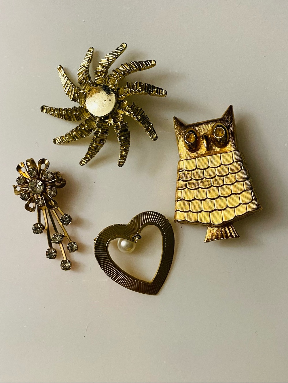 Four Vintage Gold -Tone Brooches including the Owl stamped AVON